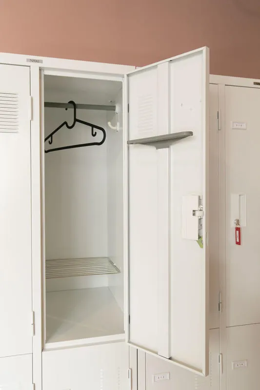 An open personal locker with a clothes hanger