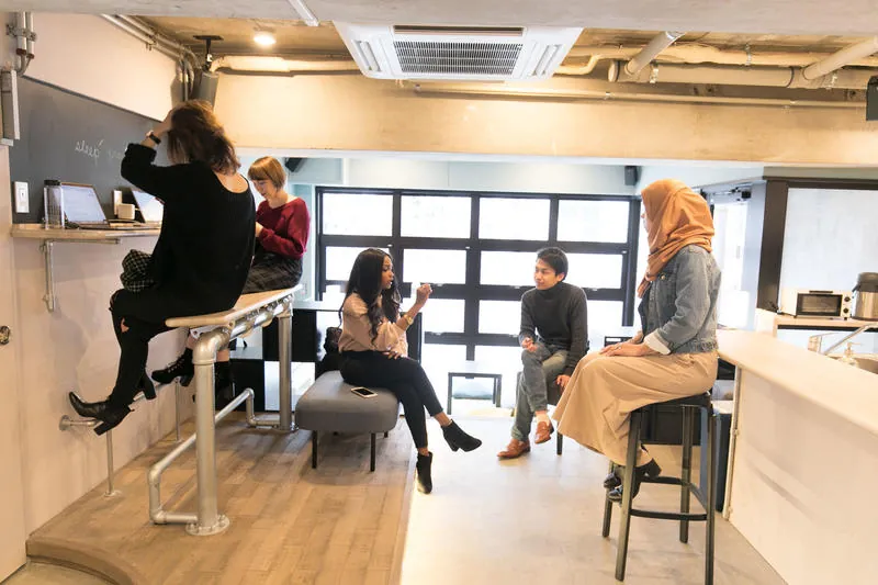 Guests chatting at the lounge counter and stools