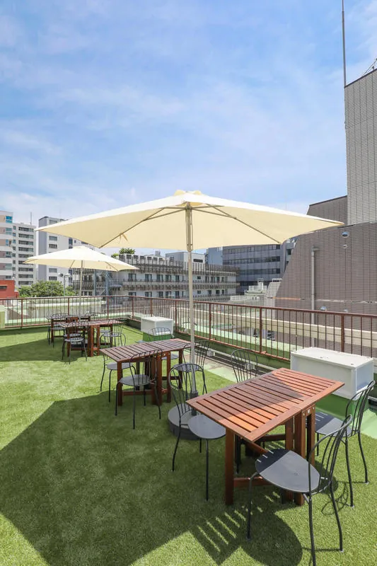 Rooftop terrace with a parasol, tables and chairs